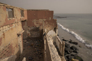 A former disco bar heavily damaged by sea waves in Bargny, Senegal on December 19, 2023. The coastal erosion began in the 1980s but worsened in the early 2000s. Storm surges have become more common and fiercer, like the passage of Hurricane Fred in the night of August 30, 2015. Bargny is currently losing three to four meters of coast each year.