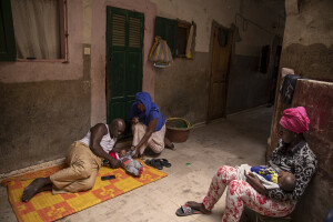 Wouly, 3 months (left) is pampered by his grandfather Souleymane, 64 years old and his mother Arame, 38 years old while Ndeye, 22 years old (right) holds her son Khadijatou, 3 months in the house where they live in the “Langue de Barbarie” in Saint-Louis, Senegal on December 15, 2023. The Senegalese government is offering money to families who leave their homes by the sea and move to Djougop temporary camp, and then proceeds to demolish those homes. The “Langue de Barbarie” is a thin, sandy peninsula located in western Senegal, where around 80,000 people live and is among the places most threatened by the rise in sea levels generated by climate change. The peninsula separates the Atlantic ocean from the final section of the Senegal river.