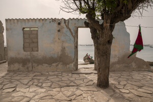 Children are seen through a sea-facing damaged wall while they play on an old barrier built around 1988 to stop the advance of the sea in Bargny, Senegal on December 19, 2023. The coastal erosion began in the 1980s but worsened in the early 2000s. Storm surges have become more common and fiercer, like the passage of Hurricane Fred in the night of August 30, 2015. Bargny is currently losing three to four meters of coast each year.