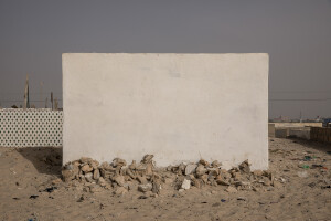 A wall and a strip of stones are seen at the entrance to the cemetery to protect it from further damage from sea waves in the Guet N’dar district of Saint-Louis, Senegal on December 11, 2023. In September 2017, a four-meter wave hit the Guet N’dar district, damaging part of the cemetery.