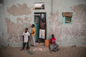 Modou (left), Doudou (center left), Hamdy (center right) and Boubacar (right) are portrayed in front of their house facing the sea in the “Langue de Barbarie” in Saint-Louis, Senegal on December 11, 2023. The “Langue de Barbarie” is a thin, sandy peninsula located in western Senegal, where around 80,000 people live and is among the places most threatened by the rise in sea levels generated by climate change. The peninsula separates the Atlantic ocean from the final section of the Senegal river.